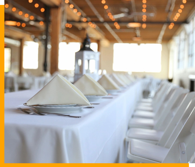 A table with white cloth and napkins on it