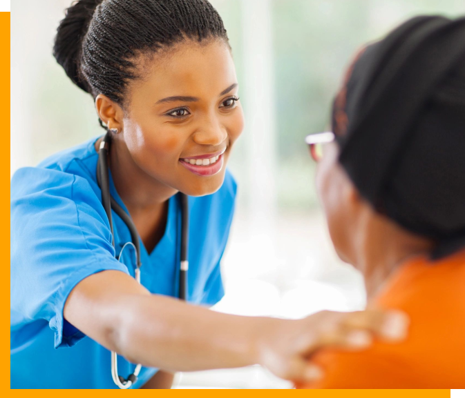 A woman in scrubs is smiling at someone.