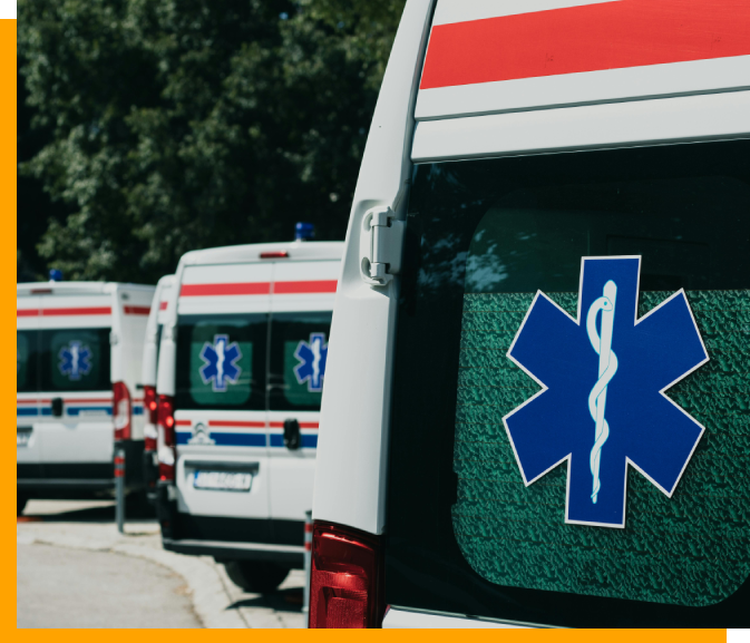 A line of ambulances parked on the side of the road.