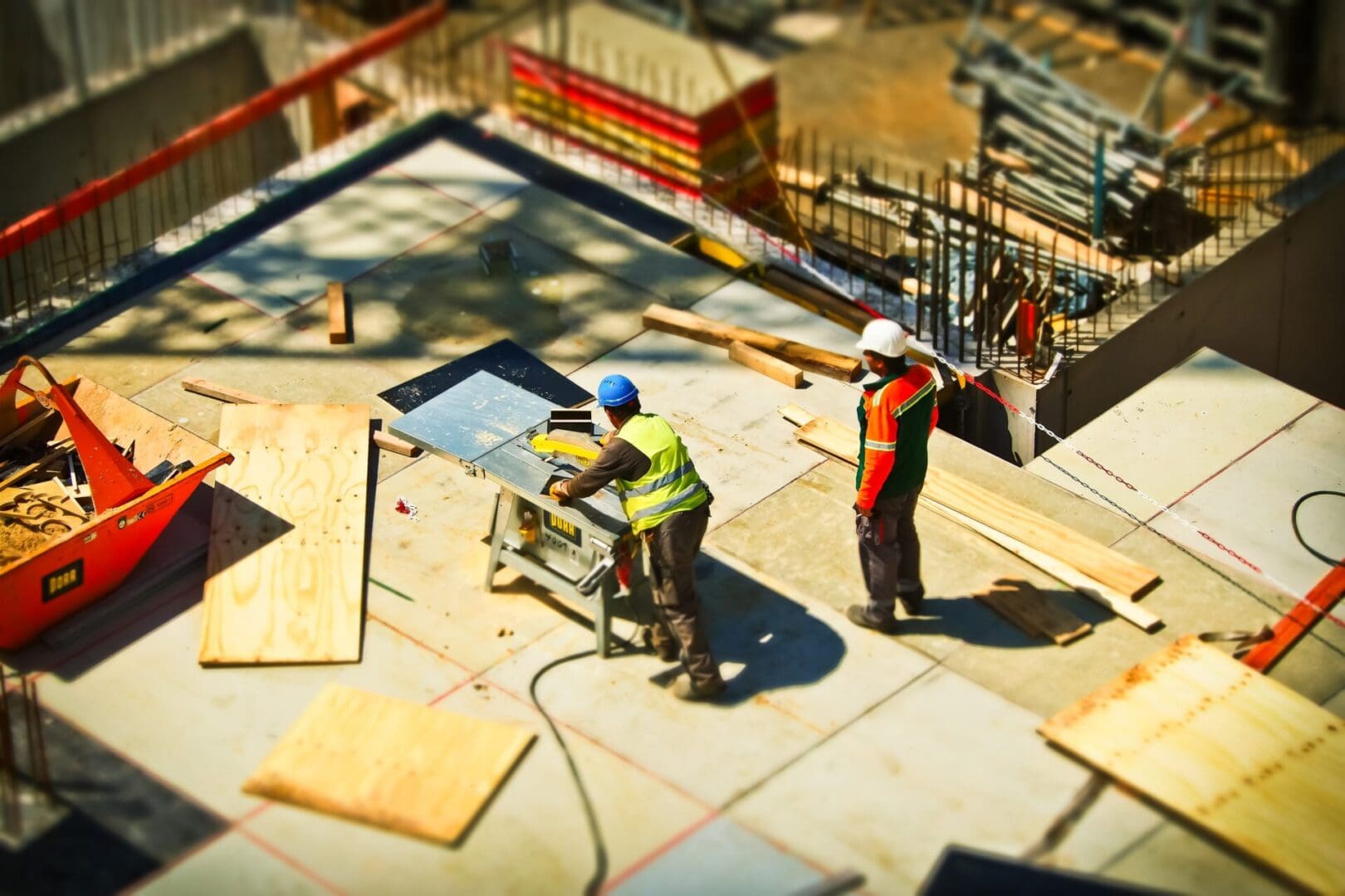 Two construction workers are working on a building.